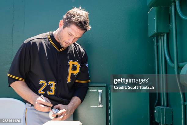 David Freese of the Pittsburgh Pirates signs a ball before the game against the Washington Nationals at Nationals Park on May 3, 2018 in Washington,...