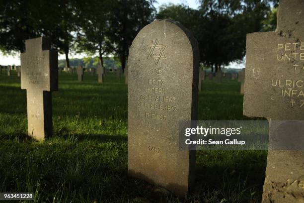 The grave of a German Jewish soldier stands among other graves in a German military cemetery that contains the remains of 8,625 German soldiers...