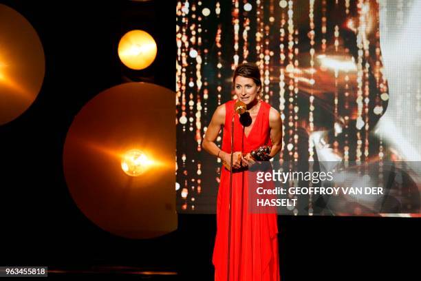 French actress Julie Cavanna holds her trophy as she speaks on stage after winning a Moliere for best female revelation in "Adieu Monsieur Haffmann"...