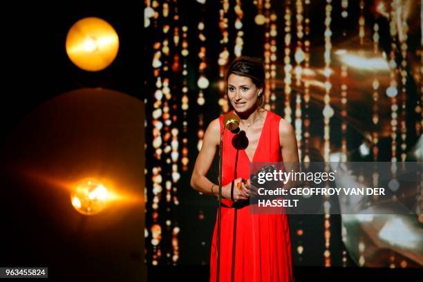 French actress Julie Cavanna holds her trophy as she speaks on stage after winning a Moliere for best female revelation in "Adieu Monsieur Haffmann"...