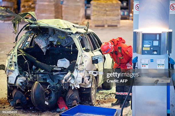 Fireman inspects the wreckage after an explosion destroyed the back of a car refueling biogas at a Statoil filling station in the suburb Gubbangen...