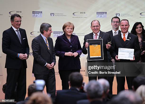 Uwe Froehlich, president of the Federal Association of the German Volksbanken and Raiffeisenbanken, Thomas Bach, president of the German Olympic...