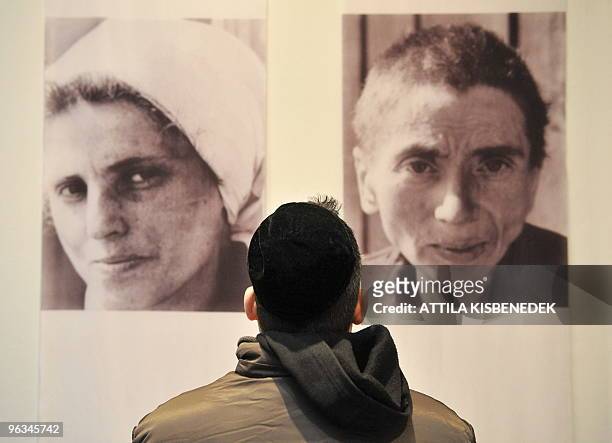 Man looks at photos from the exhibition, 'The forgotten women of Bushenwald' in the Jewish museum near the Budapest synagogue on January 18, 2010...
