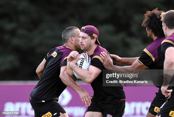 Cameron Munster takes on the defence during a Queensland Maroons State of Origin training session on May 29, 2018 in Brisbane, Australia.