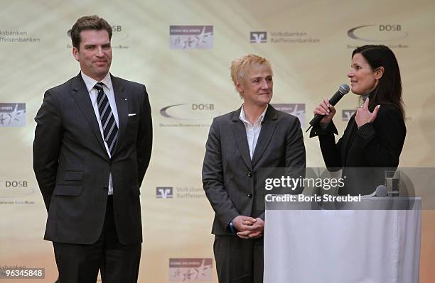 Katrin Mueller-Hohenstein of the ZDF interviews Kirsten Ulrich of Sporttreff Karower Dachse and Carsten Jung of the Berliner Volksbank after winning...