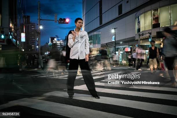 woman standing on crossing at tokyo. - otaku stock pictures, royalty-free photos & images