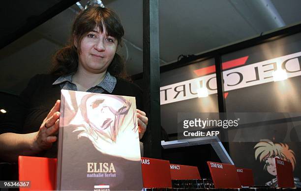 Nathalie Ferlut, French cartoonist of the comic book "Elisa" poses on January 28, 2010 on the Delcourt editions stand during the 37th edition of the...