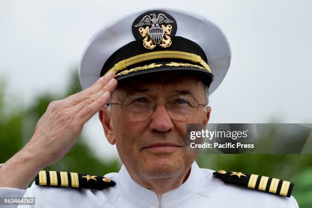 Ret. USN Capt. Louis A. Cavaliere salutes while "Taps" is played during the Memorial Day ceremony on board the retired USS Olympia, which carried...