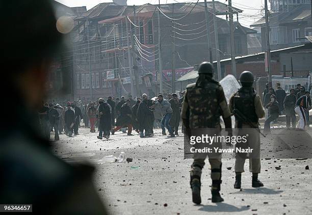 Kashmiri protesters throw stones at Indian police officers during a protest against the death of a 14 year-old Wamiq Farooq on February 02, 2010 in...