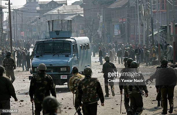 Kashmiri protesters and Indian police officers throw stones at each other during a protest against the death of a 14 year-old Wamiq Farooq on...