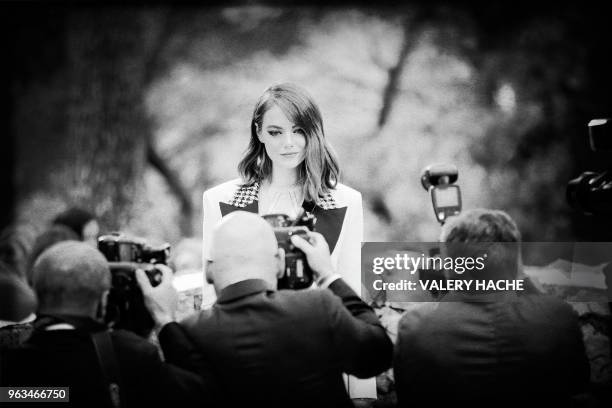 Actress Emma Stone poses for photographers during the Louis Vuitton Cruise 2019 collection fashion show at the Maeght foundation in...