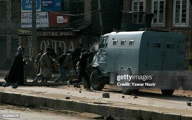 Kashmiri protesters throw stones at an armored Indian police vehicle during a protest against the death of a 14 year-old Wamiq Farooq on February 02,...