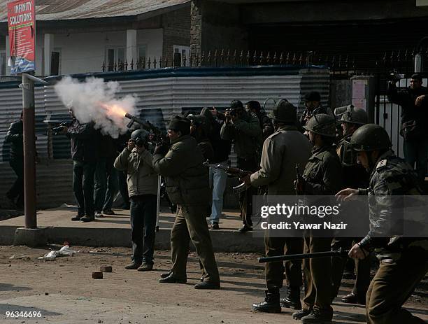 An Indian police officer fires teargas towards Kashmiri protesters during a protest against the death of a 14 year-old Wamiq Farooq on February 02,...