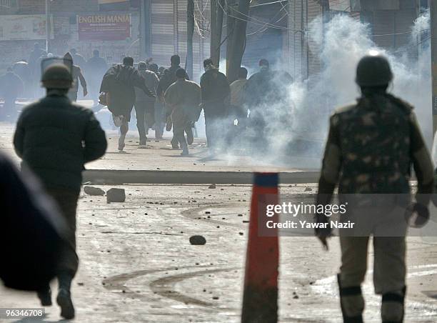 Kashmiri protesters run towards safer place as indian police officers used teargas and live rounds during a protest against the death of a 14...