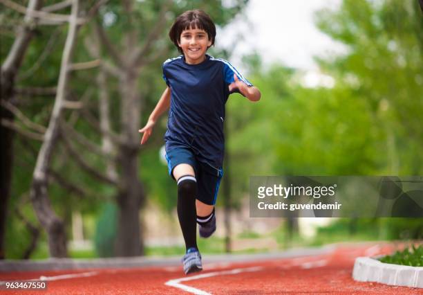 boy running on track - race 8 stock pictures, royalty-free photos & images