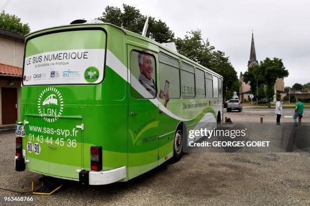 Picture taken in Villandraut, near Sauternes, southwestern France, on May 22, 2018 shows the "digital bus parked on the village square. - The...