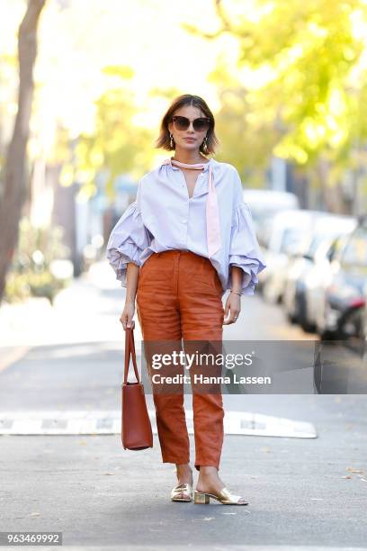 Nathalie Kelley wearing Thierry Coulson blouse, All That Remains pants, MNZ sandals, Cuero & Mor bag and Ellery seashell earrings on May 29, 2018 in...