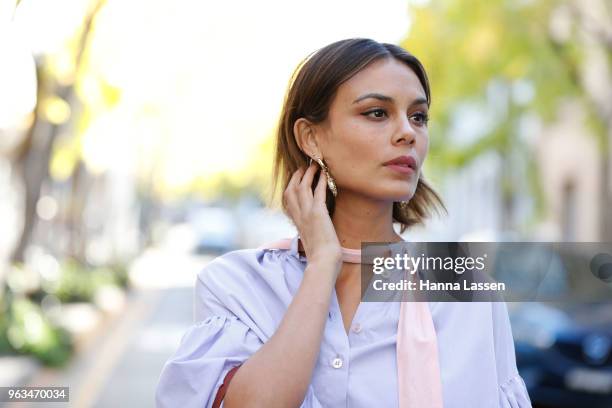 Nathalie Kelley wearing Thierry Coulson blouse, All That Remains pants, MNZ sandals, Cuero & Mor bag and Ellery seashell earrings on May 29, 2018 in...