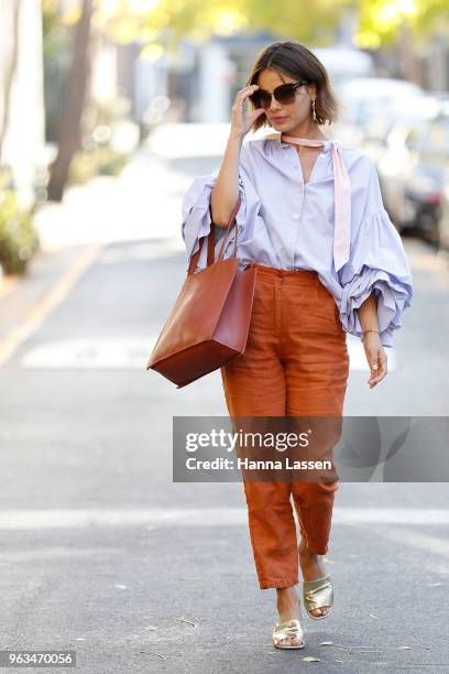 Nathalie Kelley wearing Thierry Coulson blouse, All That Remains pants, MNZ sandals, Cuero & Mor bag and Ellery seashell earrings on May 29, 2018 in...