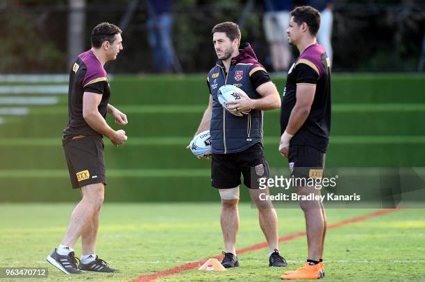 Billy Slater, Ben Hunt and Dane Gagai talk tactics during a Queensland Maroons State of Origin training session on May 29, 2018 in Brisbane,...