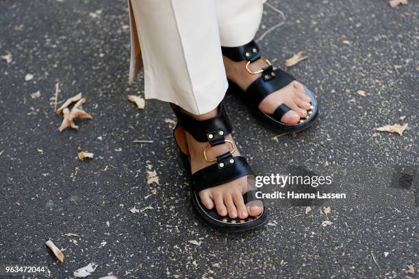 Alex Teo, shoe detail, wearing Khaite pants and jacket, Shaina Mote sweater and Isabel Marant sandals on May 29, 2018 in Sydney, Australia.