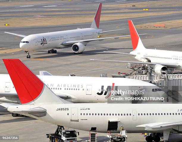 In a picture taken on January 29, 2010 jetliners from Asia's largest air carrier Japan Airlines taxi on the tarmc at Tokyo's Haneda airport. A...