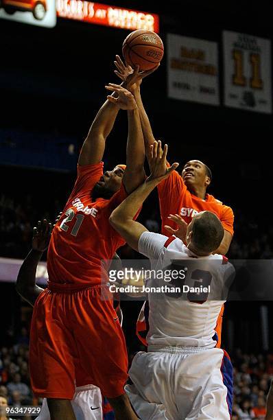 Arinze Onuaku and Wes Johnson of the Syracuse Orange leap for a rebound over Kris Faber of the DePaul Blue Demons at the Allstate Arena on January...