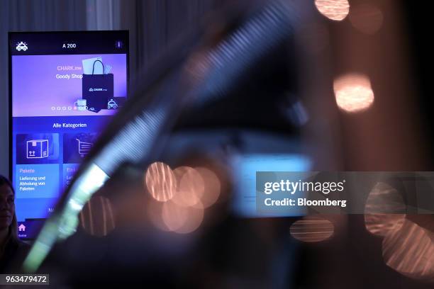 An oversized smartphone screen displays a Chark.me logo illustration during a demonstration for the retail delivery access and service provider app...