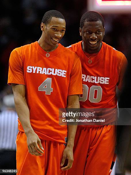 Wes Johnson and Rick Jackson of the Syracuse Orange smile as they walk off the court following a close win over the DePaul Blue Demons at the...
