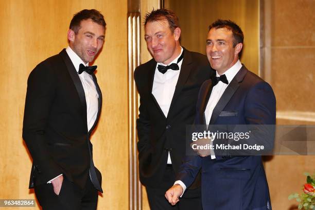 Geelong Cats head coach Chris Scott is seen with former Cats footballer Corey Enright and Darren Milburn during the Australian Football Hall of Fame...