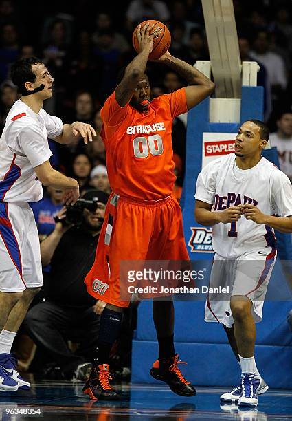 Rick Jackson of the Syracuse Orange grabs a rebound between Mario Stula and Mike Stovall of the DePaul Blue Demons at the Allstate Arena on January...