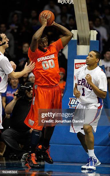 Rick Jackson of the Syracuse Orange grabs a rebound between Mario Stula and Mike Stovall of the DePaul Blue Demons at the Allstate Arena on January...