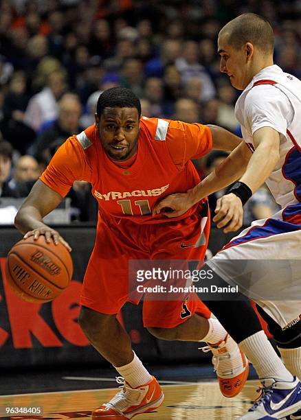 Scoop Jardine of the Syracuse Orange moves against Michael Bizoukas of the DePaul Blue Demons at the Allstate Arena on January 30, 2010 in Rosemont,...