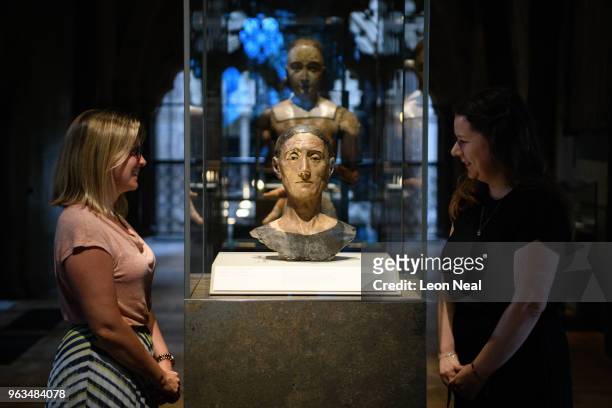 Two gallery asisstants pose with a funeral effigy of King Henry VII in the Queen's Diamond Jubilee gallery at Westminster Abbey on May 29, 2018 in...