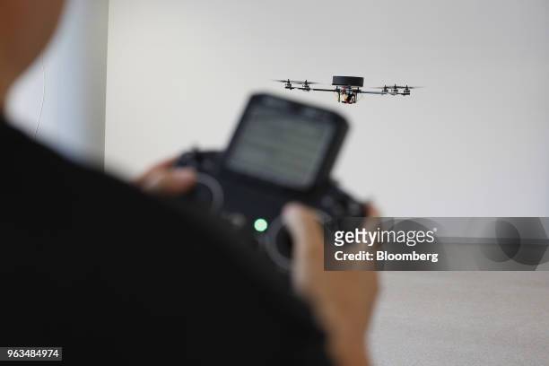 An employee controls an octocopter drone as it flies inside the Volocopter GmbH headquarters in Bruchsal, Germany, on Monday, May 28, 2018. The...