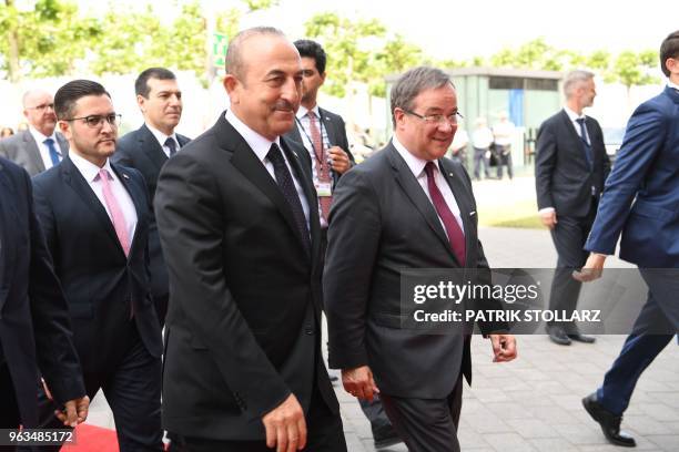 North Rhine-Westphalia's State Premier Armin Laschet welcomes Turkish Foreign Minister Mevlut Cavusoglu and his delegation before a ceremony marking...