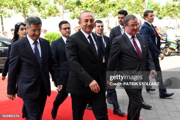 North Rhine-Westphalia's State Premier Armin Laschet welcomes Turkish Foreign Minister Mevlut Cavusoglu and his delegation before a ceremony marking...