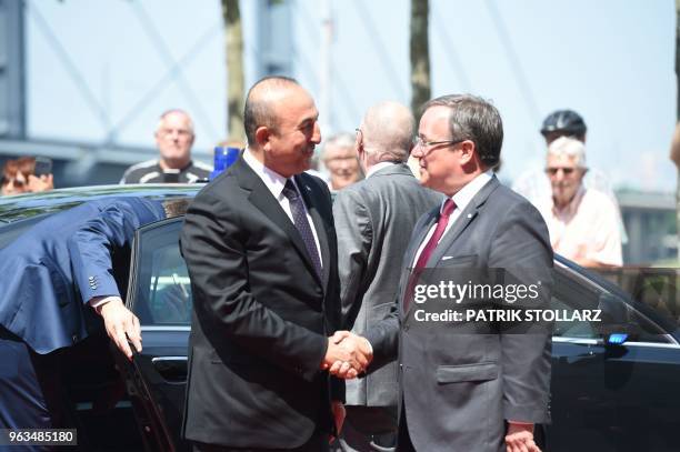 North Rhine-Westphalia's State Premier Armin Laschet welcomes Turkish Foreign Minister Mevlut Cavusoglu and his delegation before a ceremony marking...