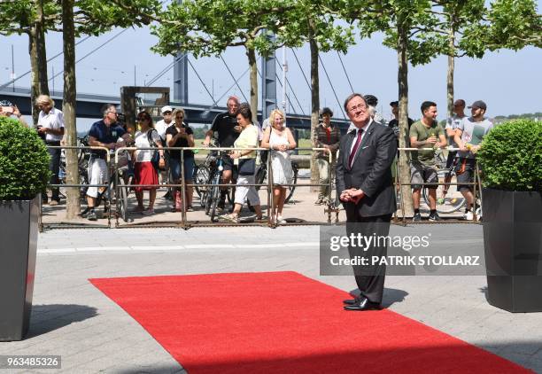 North Rhine-Westphalia's State Premier Armin Laschet reacts as he awaits for Turkish Foreign Minister Mevlut Cavusoglu and his delegation before a...