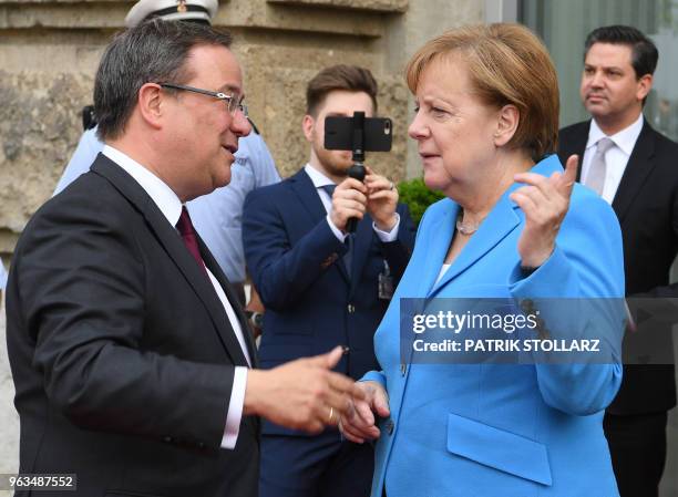 German Chancellor Angela Merkel is welcomed by North Rhine-Westphalia's State Premier Armin Laschet for a ceremony marking the 25th anniversary of an...