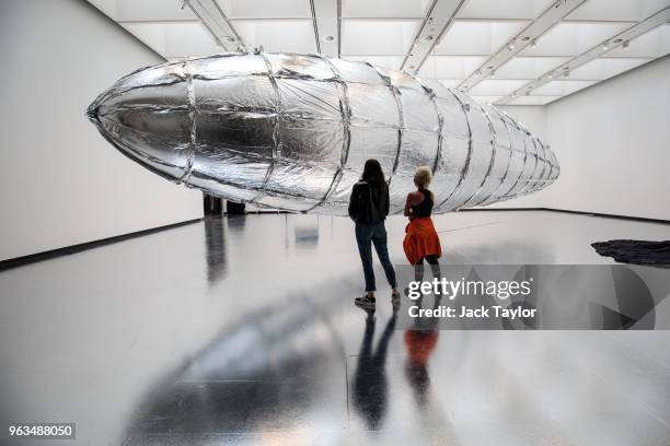 Gallery employees pose with 'Willing To Be Vulnerable', by Lee Bul during a photocall for a new exhibition called 'Crashing' at The Hayward Gallery...