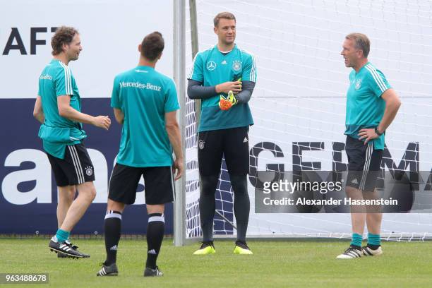 Manuel Neuer talks to his coaches Marus Sorg , Miroslav Klose and Andreas Koepcke looks on during a training session of the German national team at...