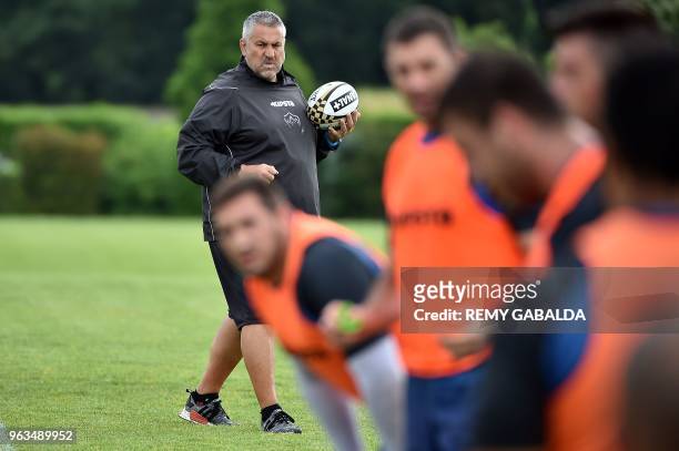 Castres' coach Christophe Urios looks on during a training at Levezou stadium in Saix, near Castres, southern France, on May 29 ahead of the Top 14...