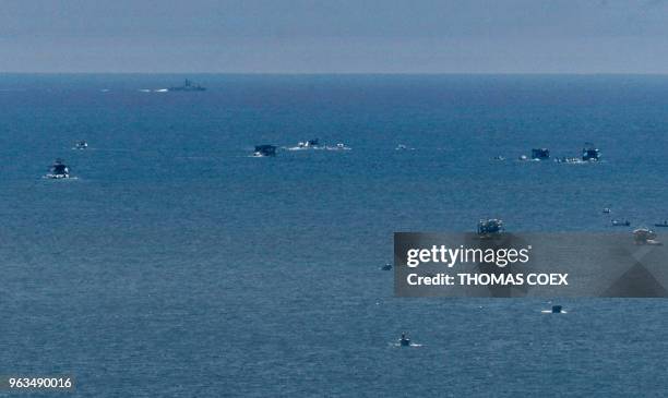 Picture taken on May 29, 2018 shows an Israeli naval ship patrolling as fishing boats carrying a group of Palestinian activists who are protesting...