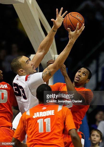 Kris Faber of the DePaul Blue Demons grabs a rebound between Scoop Jardine and Kris Joseph of the Syracuse Orange at the Allstate Arena on January...