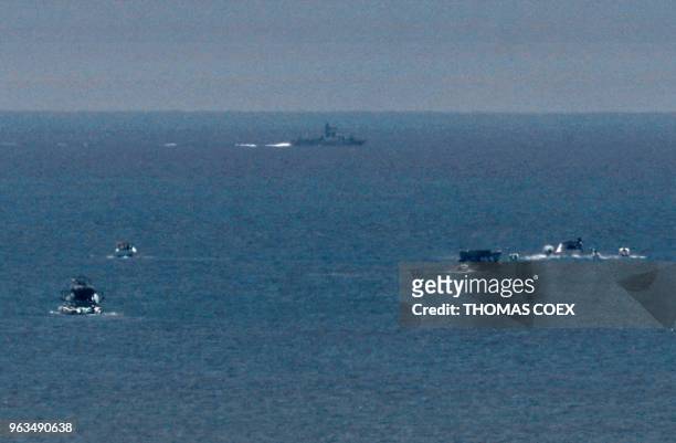 Picture taken on May 29, 2018 shows an Israeli naval ship patrolling as fishing boats carrying a group of Palestinian activists who are protesting...