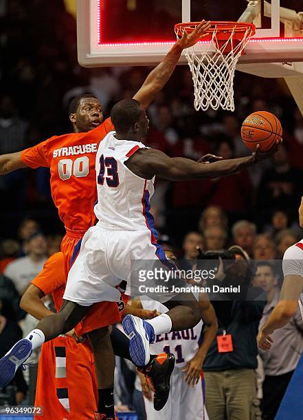 Mac Koshwal of the DePaul Blue Demons puts up a shot as time expires against Rick Jackson of the Syracuse Orange at the Allstate Arena on January 30,...