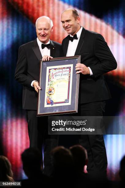 Inductee David Neitz accepts his award from AFL commission chairman Richard Goyder during the Australian Football Hall of Fame at Crown Palladium on...