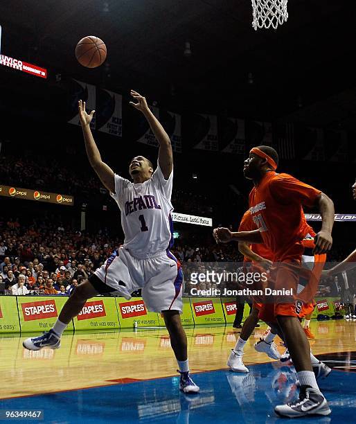 Mike Stovall of the DePaul Blue Demons grabs a rebound against Arinze Onuaku of the Syracuse Orange at the Allstate Arena on January 30, 2010 in...