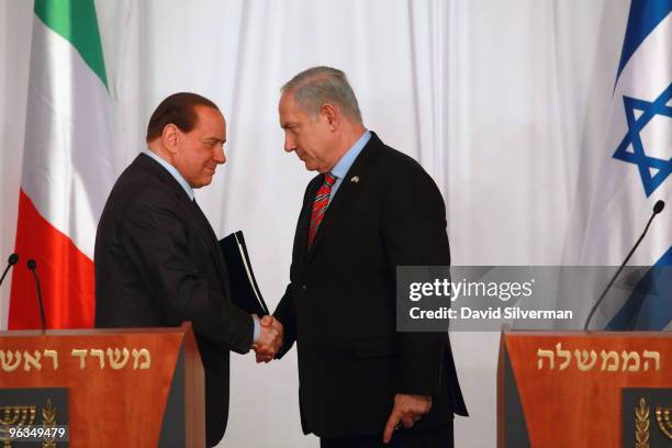 Israeli Prime Minister Benjamin Netanyahu and his visiting Italian counterpart Silvio Berlusconi shake hands at the end of their press conference and...